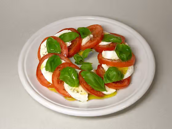 Salad Caprese — Insalata caprese , made from mozzarella, tomatoes, olive oil and basil.