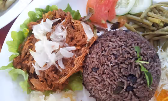 Moros y Cristianos (dish) — Typical Cuban dinner consisting of ropa vieja (shredded flank steak in a tomato sauce base), black beans, rice, fried bananas and different vegetables.
