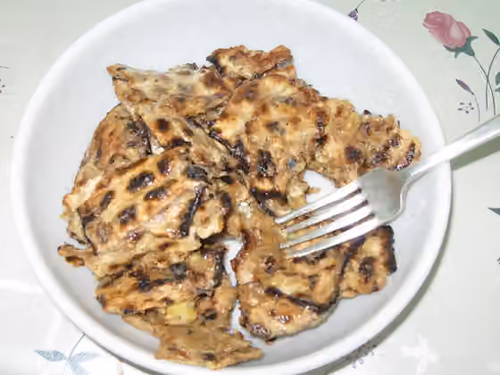 Matzah brei — A portion of matzah brei (broken matzah soaked in beaten egg and fried), a popular Passover dish