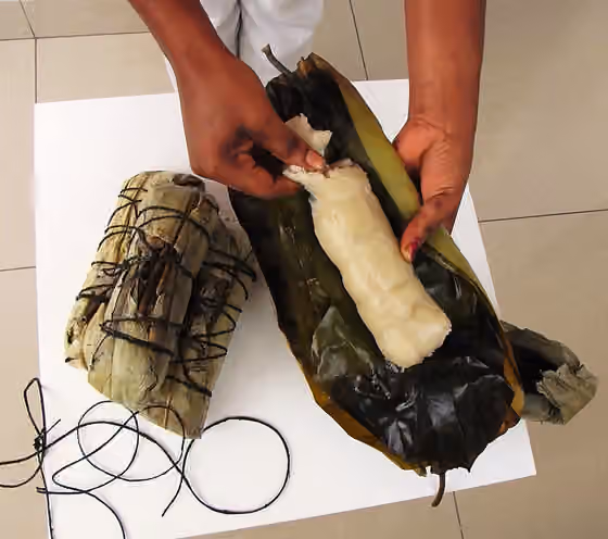 Chikwangue — A stack of fully-cooked, leaf-wrapped packets as sold on the street, also with the leaves unwrapped to show the ready-to-eat cassava 'bread.' If kept in the cooked leaf wrap, it is quite hygienic and will usually stay fresh for several…