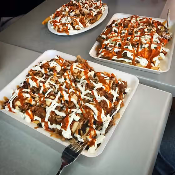 Paket makanan ringan halal — Three Halal snack packs on Styrofoam plates.
