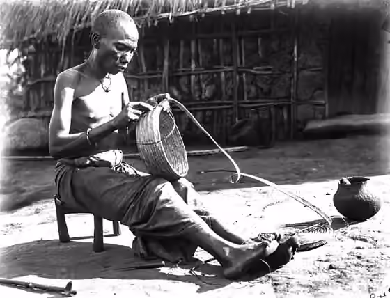 Bondei people — Bondei man braiding a basket c.1901.